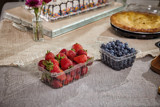 fresh blueberries and strawberries in clear containers from the grocery store	