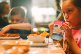 children enjoying a meal at a table	