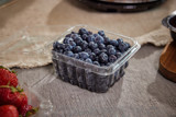 fresh blueberries in a clear container from the grocery store	