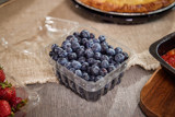 fresh blueberries in a clear container from the grocery store	