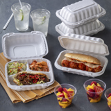 take out container with three divider sections for a beef sandwich, side salad, and kimchi, and another takeout container for a meatball sub