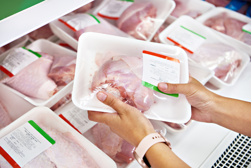 raw meat inside of a white meat tray in the grocery store