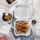 chicken and waffles in a takeout container