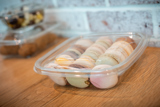 clear container with two dozen different flavor Macarons