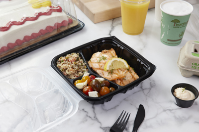 salmon entree in a hinge lid take out container with compartments for the entree and two sides	