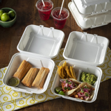 three tamales in a takeout container and two tacos, side of chips, and side of guacamole in a three section divider container	