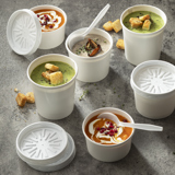 round white soup containers with different kinds of soups inside	