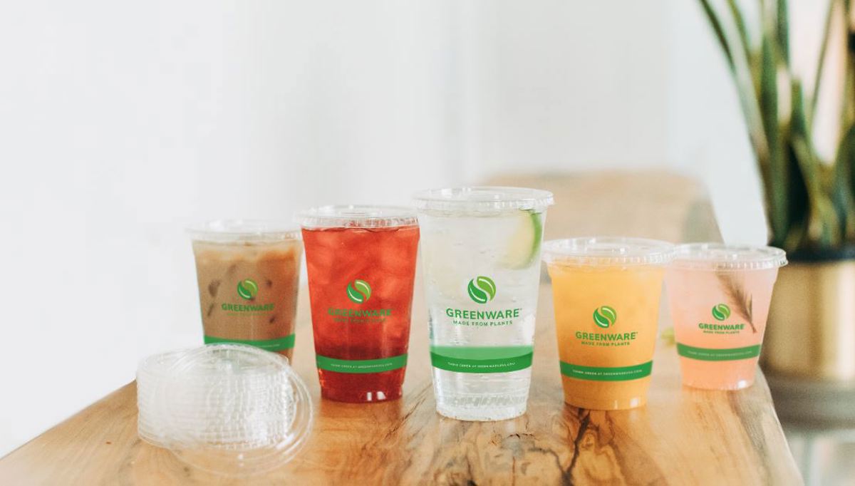 Variety of Greenware clear cups with different beverages inside	