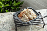 Take out container with fried chicken and mashed potatoes