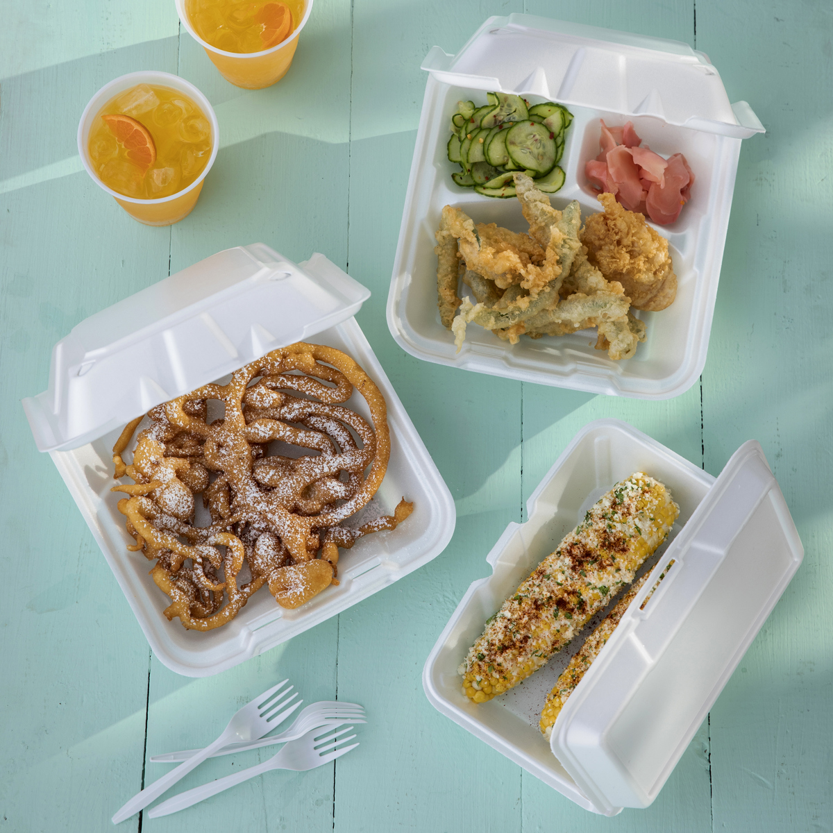 variety of different foods in different kinds of white takeout containers