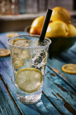 clear cold beverage cup with iced lemon water inside	