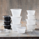 one dozen different sized clear and black portion cups for side sauces