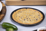 whole cookie cake on a round black tray	