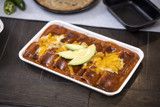 white tray with red sauce Enchiladas	