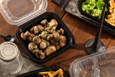 side of mushrooms in a takeout container