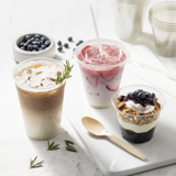 iced coffee, an iced strawberry drink, and a small yogurt parfait in different size clear cups	