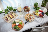 catering platters and catering utensils with a variety of foods	