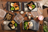 dinner foods at a dining table in dinner two piece takeout containers	