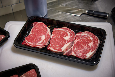 Raw red meat in a black meat tray	