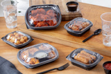 variety of different fried foods like fried chicken, tater tots, and Mozzarella sticks in takeout containers good for crispy foods	