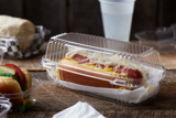 clear hinge lid hot dog container with a Sauerkraut style hot dog inside