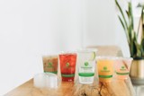 clear greenware cups with iced beverages inside	