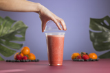 clear to go smoothie cup with a berry smoothie inside