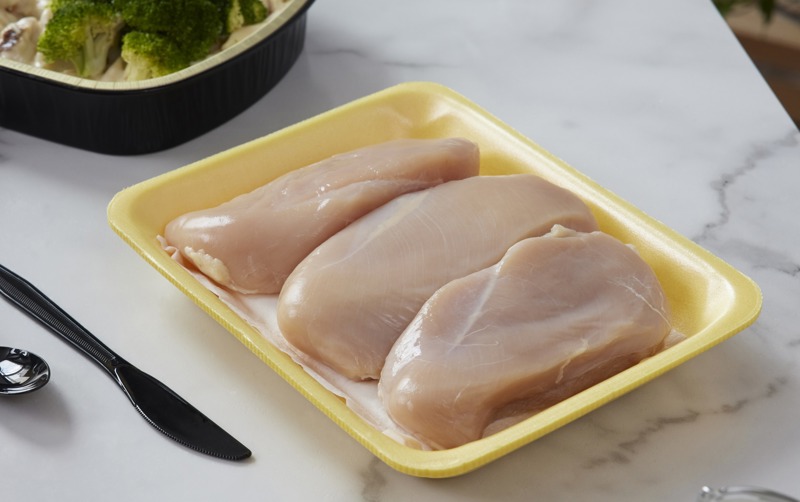 Pactiv Evergreen meat tray with raw boneless skinless chicken breast