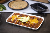 white tray with red sauce Enchiladas	