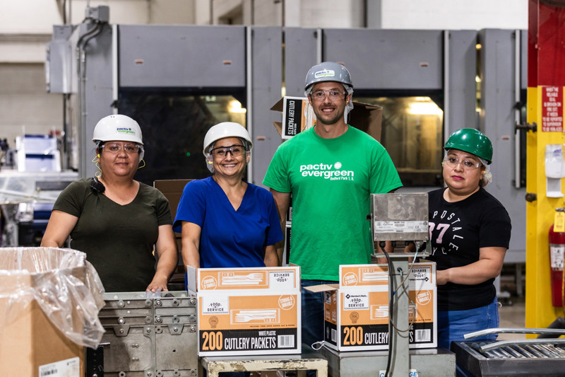 group of four pactiv evergreen employees at one of pactiv evergreens manufacturing facilities