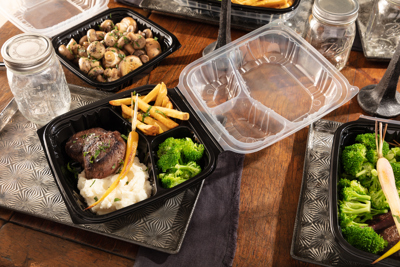 dinner foods at a dining table in dinner two piece takeout containers	