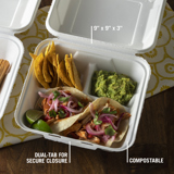 two tacos, side of chips, and side of guacamole in a three section divider container	