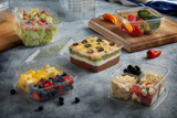 variety of food items in clear square packaging	