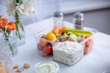 square shaped clear container with fresh veggies and a section with ranch dip