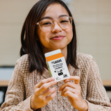 child smiling and holding a milk carton